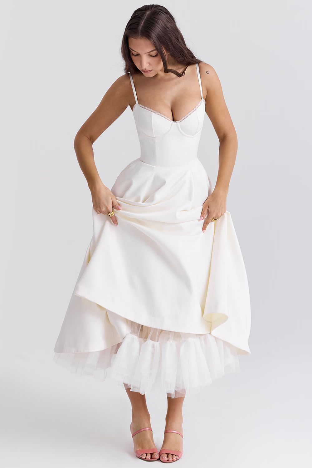 White satin midi dress with spaghetti straps, sweetheart neckline, and tulle underlayer