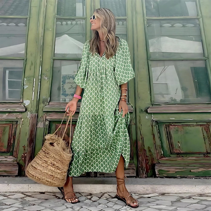 Green patterned spring dress with white geometric trellis, elbow sleeves and V neckline