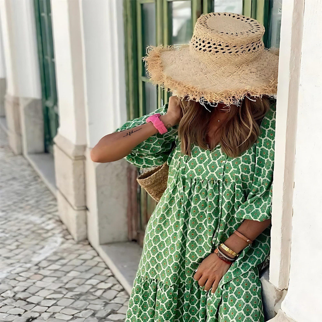Green patterned spring dress with white geometric trellis, gathered yoke and tiered hem