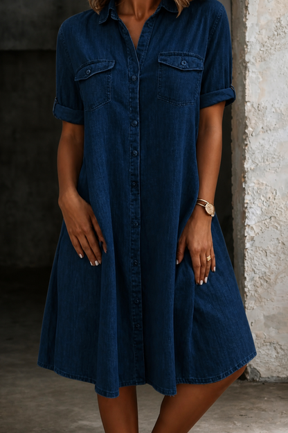 Dark navy denim midi dress with short sleeves, button front, and chest flap pockets