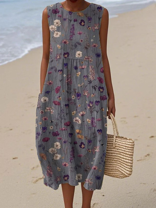 Floral midi dress, sleeveless with round neckline, slate blue ground and multicolor flowers.