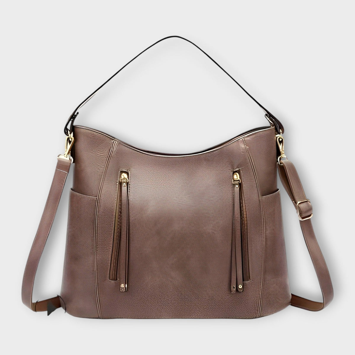 Taupe leather hobo handbag with zip front, tassel details, and shoulder straps.