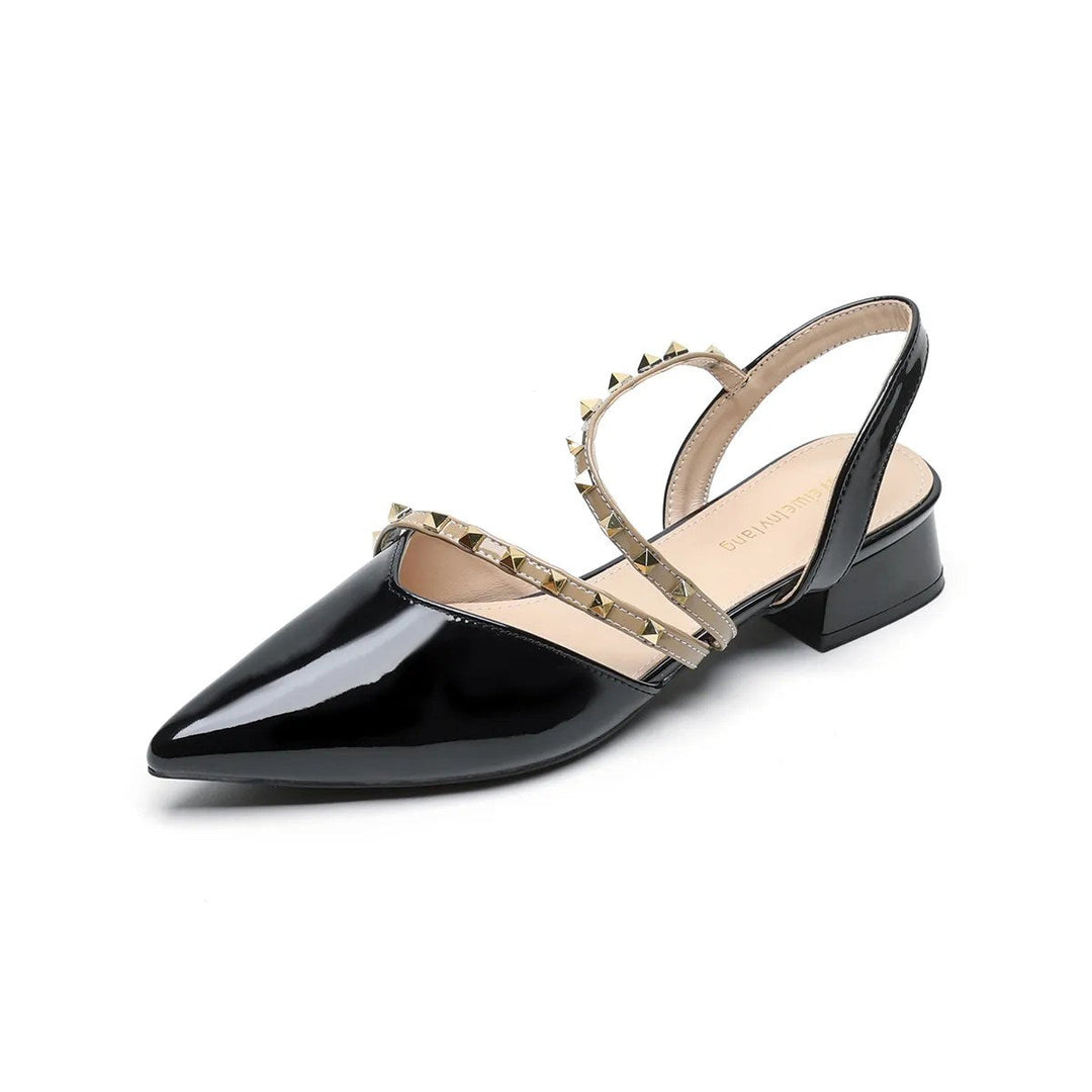 Black orthopedic heels with pointed toe, strappy upper, and gold-tone stud trim