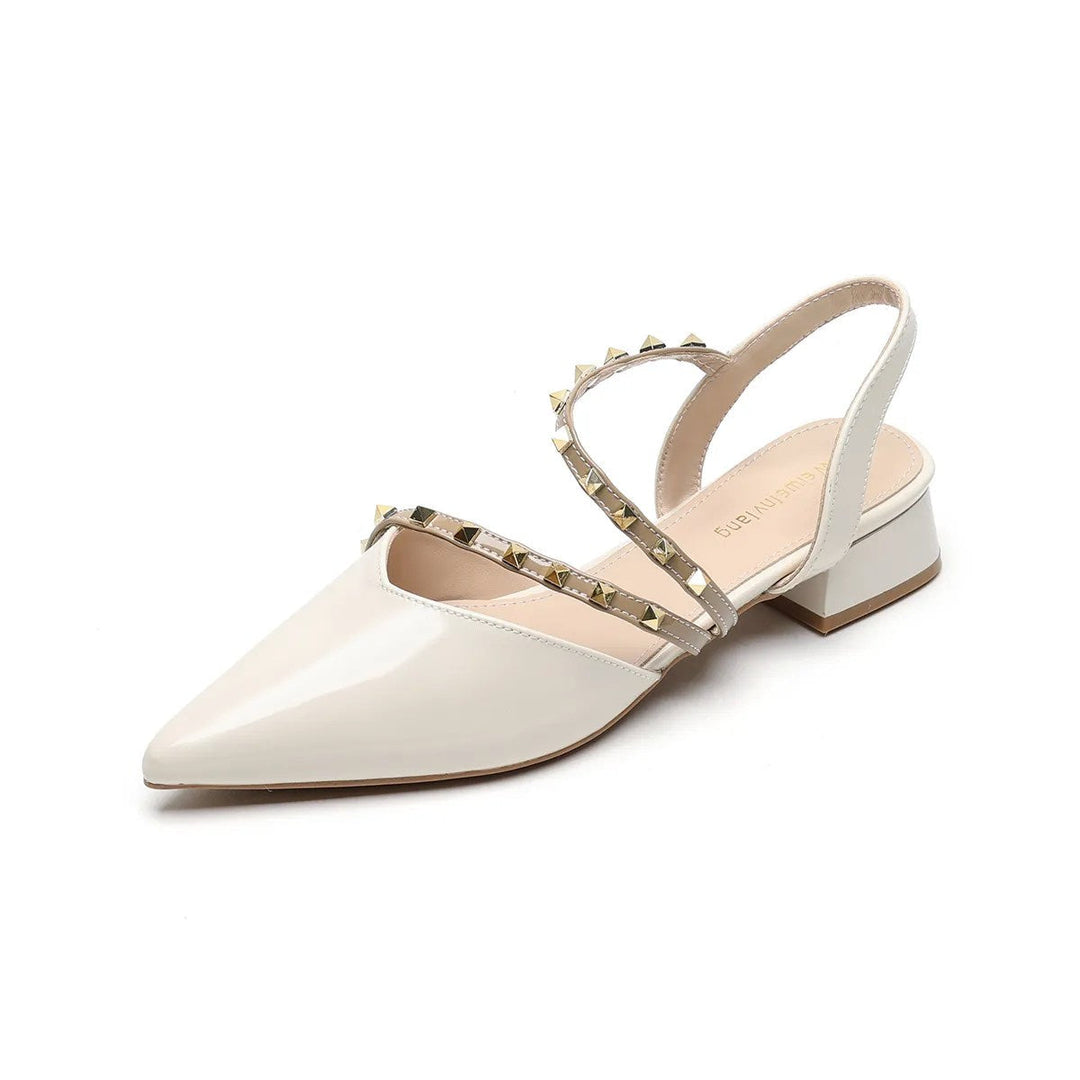 Beige orthopedic heels with pointed toe, strappy upper, and gold-tone stud trim