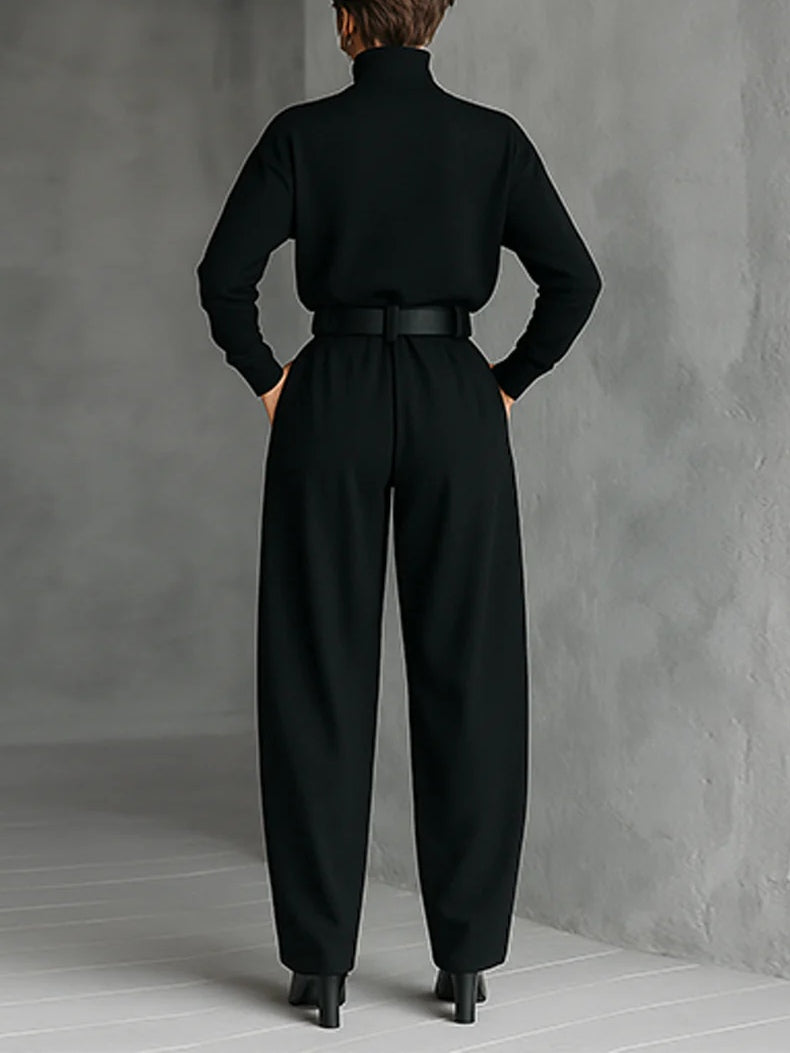 Black fitted turtleneck top and straight-leg trousers set from back with wide belt