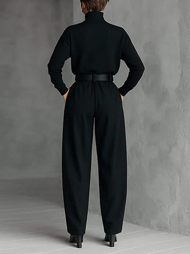 Black fitted turtleneck top and straight-leg trousers set from back with wide belt