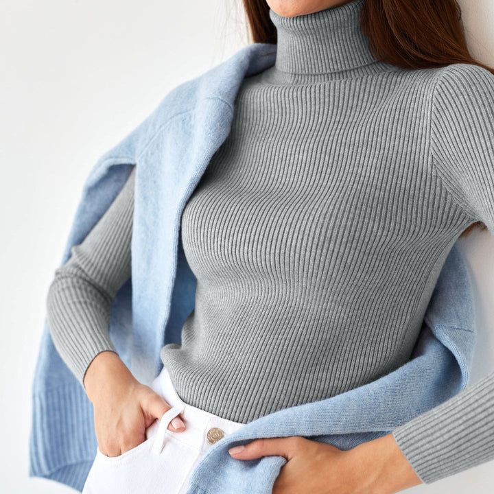 Gray ribbed turtleneck sweater with long sleeves and a firm, high knit collar
