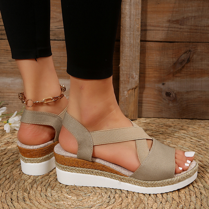 Beige canvas espadrille platform sandals with wide cross straps and ankle strap