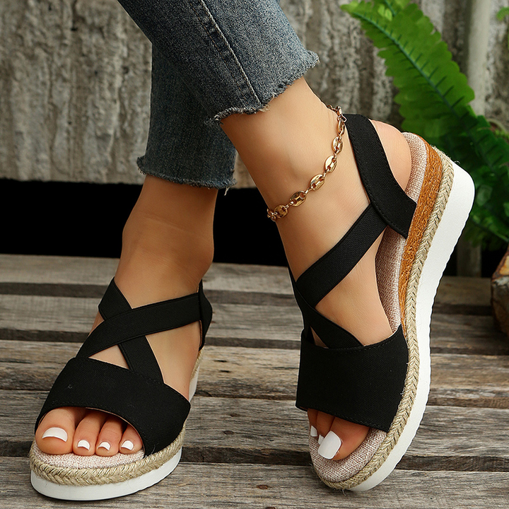 Black canvas espadrille wedge sandals with wide crisscross straps and ankle strap