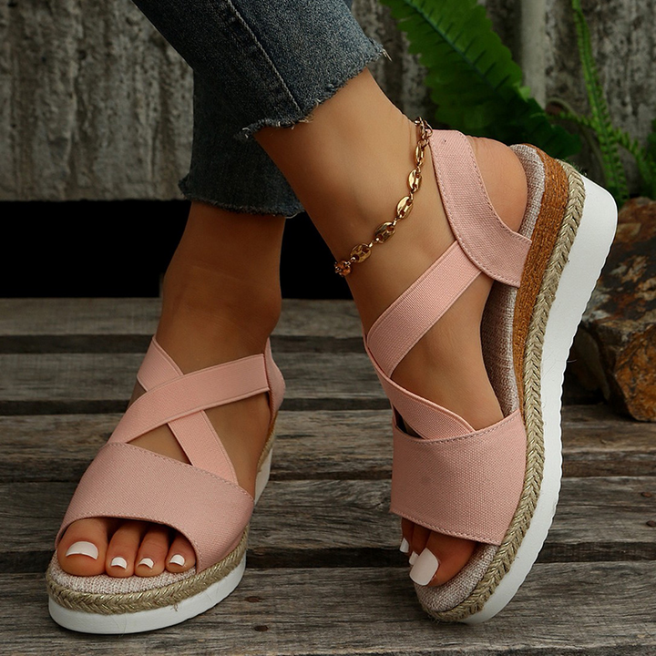 Pink canvas espadrille platform sandals with wide crisscross straps and ankle strap