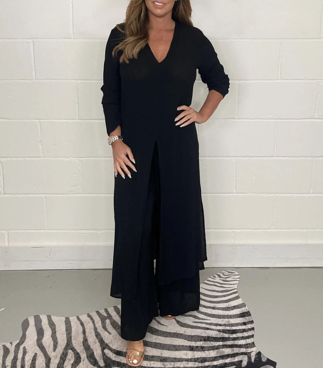 Black two-piece set with V-neck flowy blouse and wide-leg trousers, long side slit
