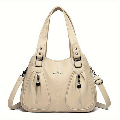 Women’s casual shoulder bag in cream with top handles and adjustable shoulder strap.