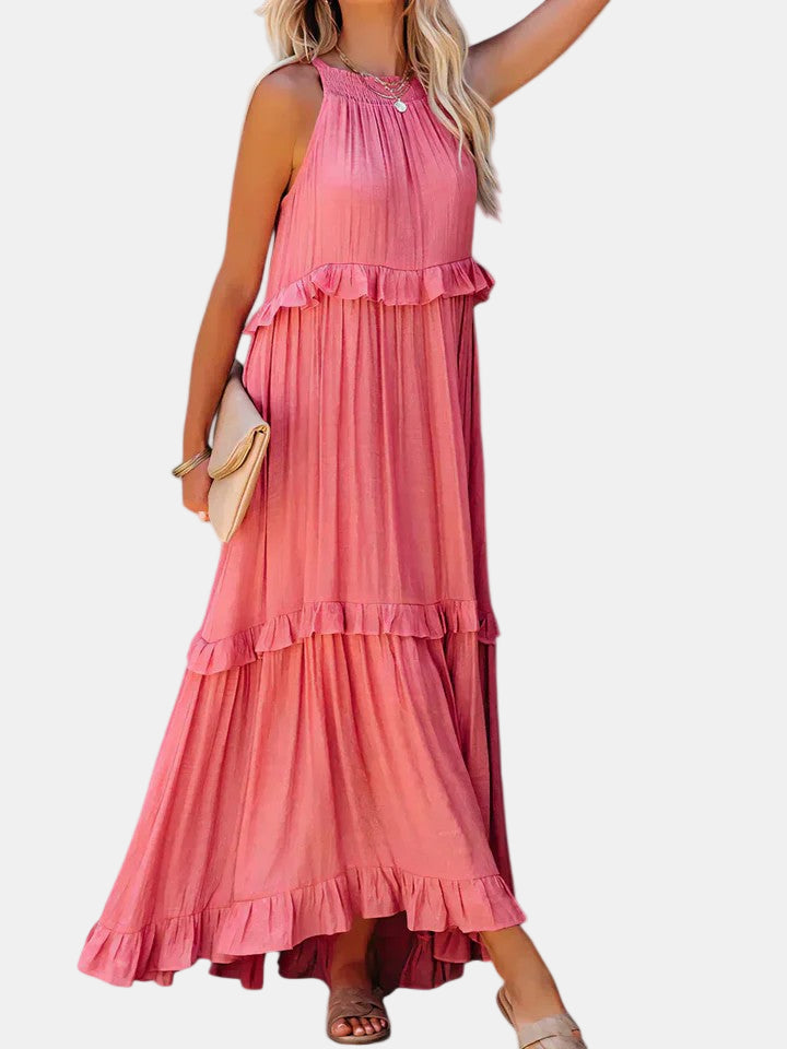 Pink long dress with sleeveless halter, tiered ruffles, and flowing maxi skirt