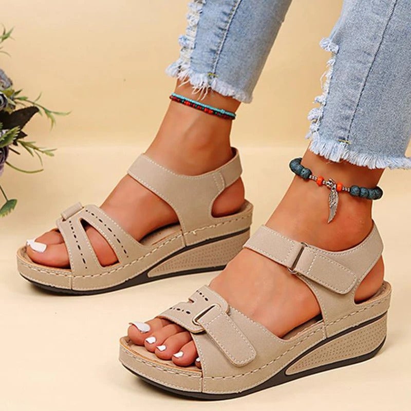 Women’s beige platform sandals with two straps and adjustable buckles on wedge sole