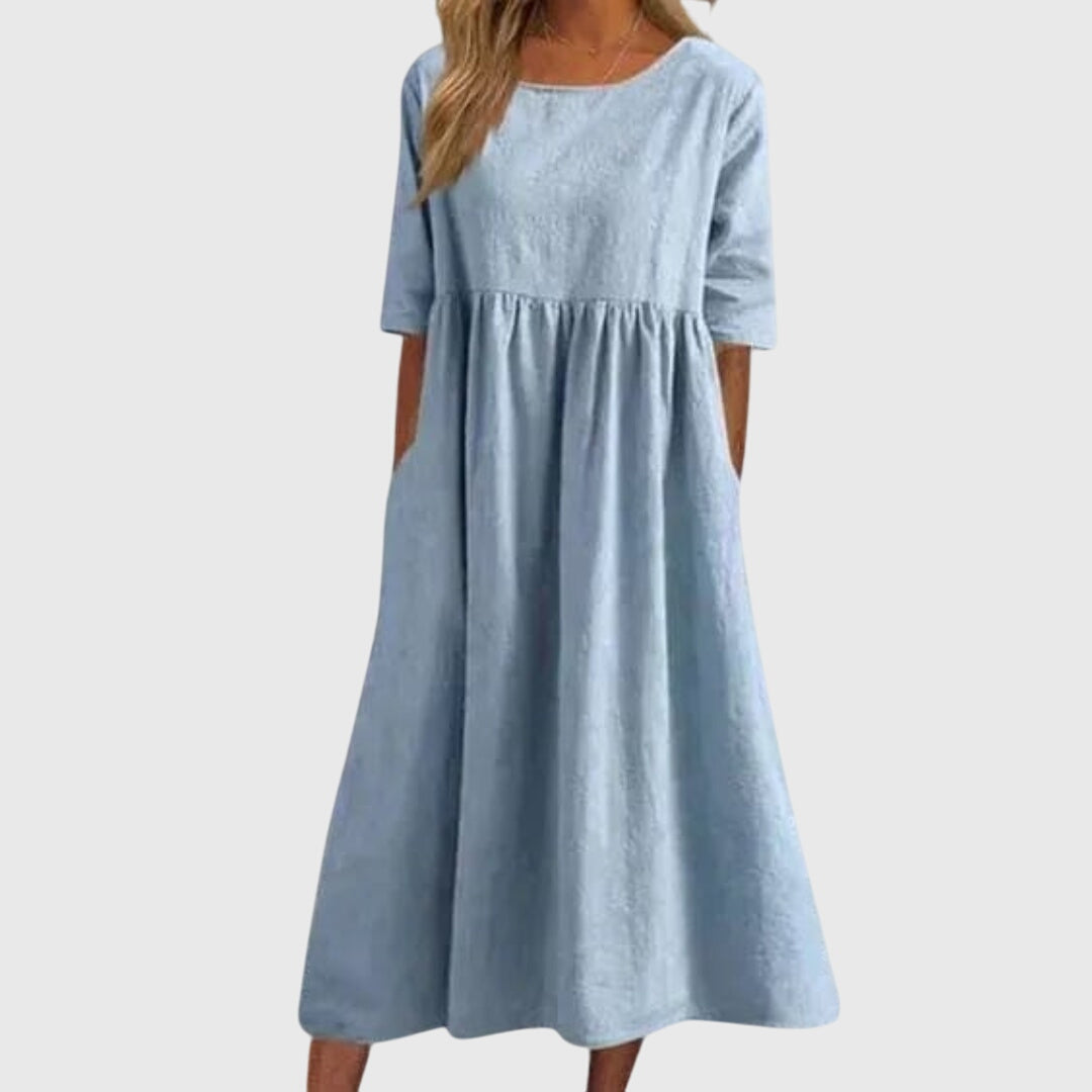 Light blue short-sleeve dress with round neck, gathered waist, and full midi skirt