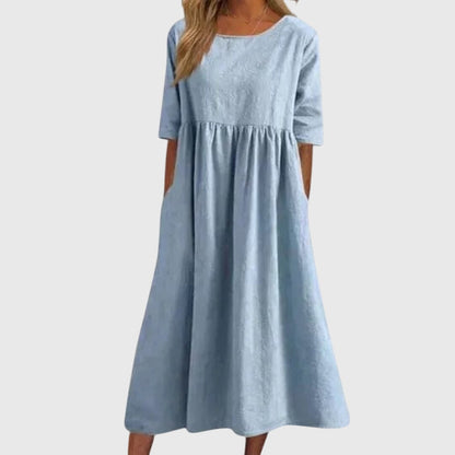 Light blue short-sleeve dress with round neck, gathered waist, and full midi skirt
