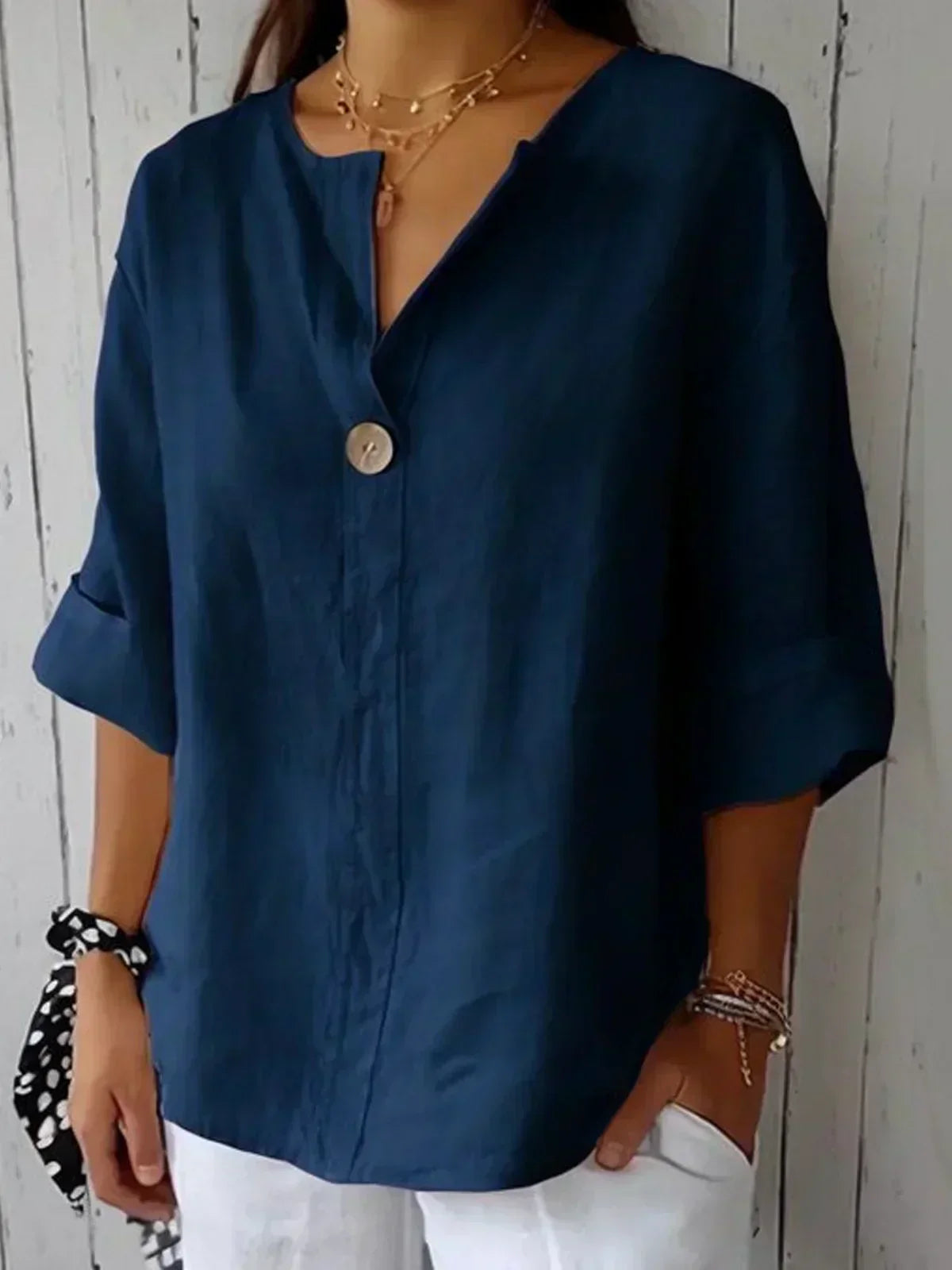 Navy V-neck blouse with button front and elbow-length sleeves