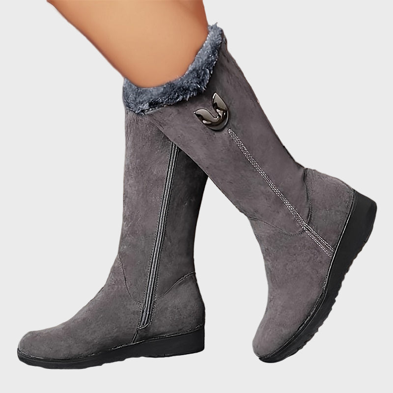 Gray mid-calf boots with faux fur cuff, side zipper, and decorative buckle detail