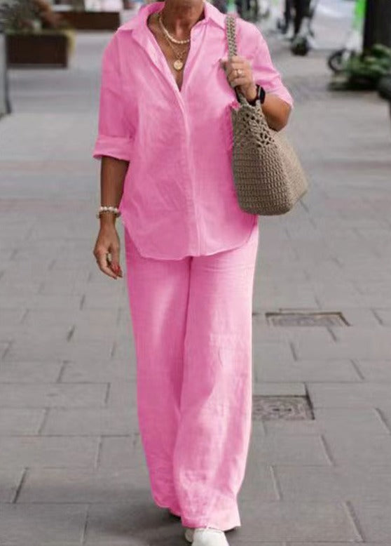 Pink two-piece set: relaxed button-up top and wide-leg trousers.