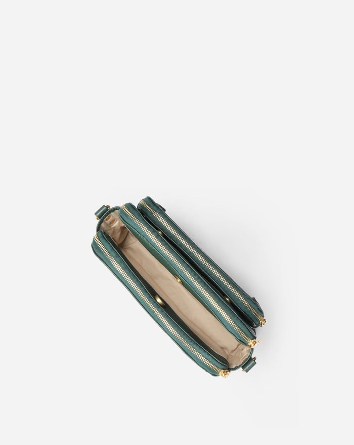 Jovie deep green crossbody bag, side view with three zip tracks and adjustable strap