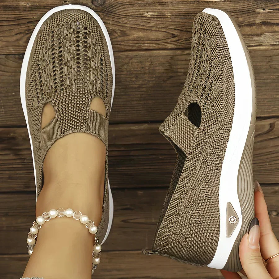 Beige orthopedic slip-on shoes with knit upper, cutout openings, and white cushioned sole