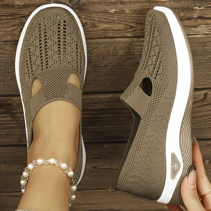 Beige orthopedic slip-on shoes with knit upper, cutout openings, and white cushioned sole
