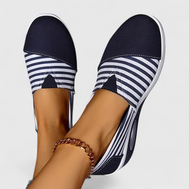 Anika orthopedic slip-on sneakers, navy with white striped instep and oval window on sole