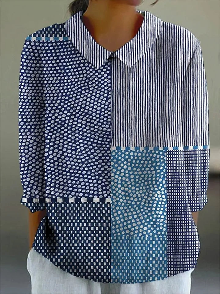 Patchwork blouse with striped, polka-dot, and teal blocks, collared button-up front.