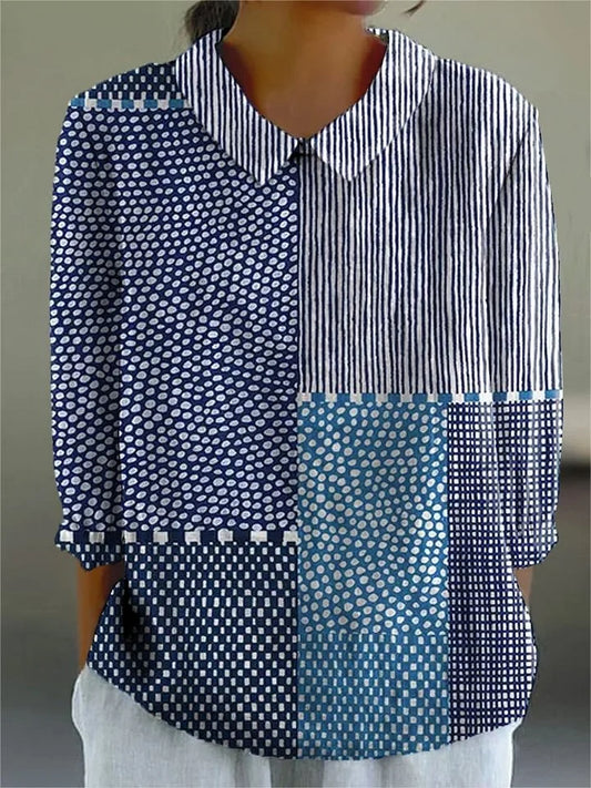 Patchwork blouse with striped, polka-dot, and teal blocks, collared button-up front.