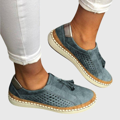 Blue orthopedic slip-on shoes with tassel detail and perforated upper, cushioned outsole