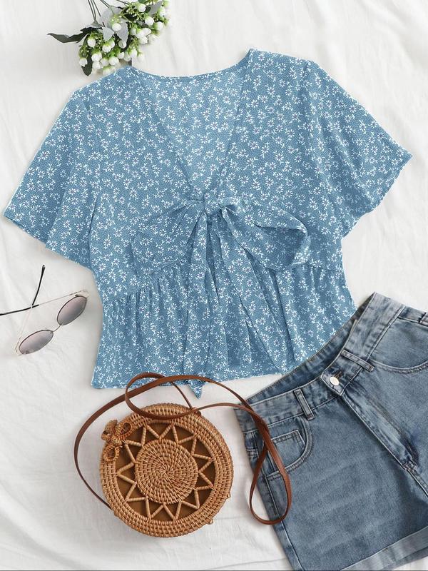 Light blue floral v-neck flowy top with short sleeves and tied front detail