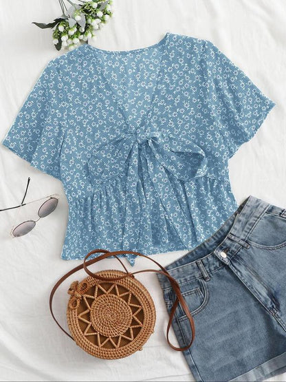 Light blue floral v-neck flowy top with short sleeves and tied front detail
