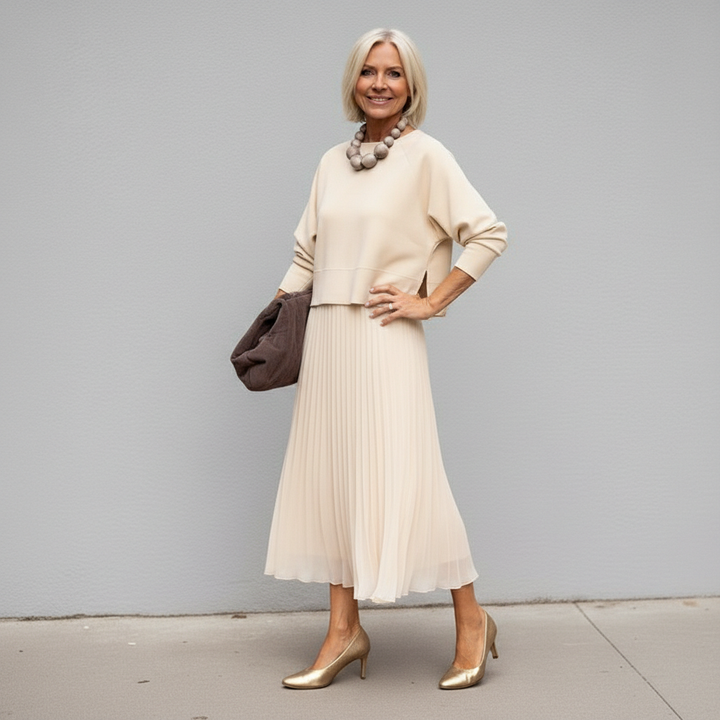 Ivory knit layered dress set with three-quarter sleeves and pleated tulle midi skirt