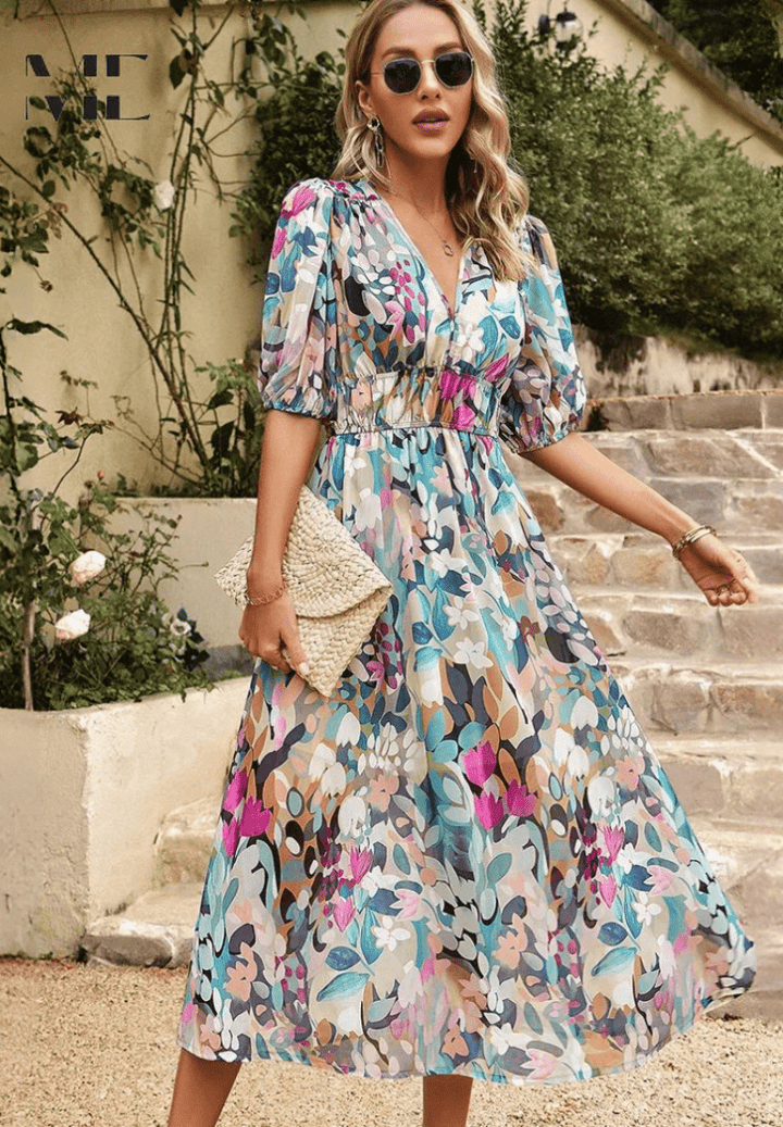 Floral midi dress with V-neck and puff sleeves, gathered waist, holding a woven clutch