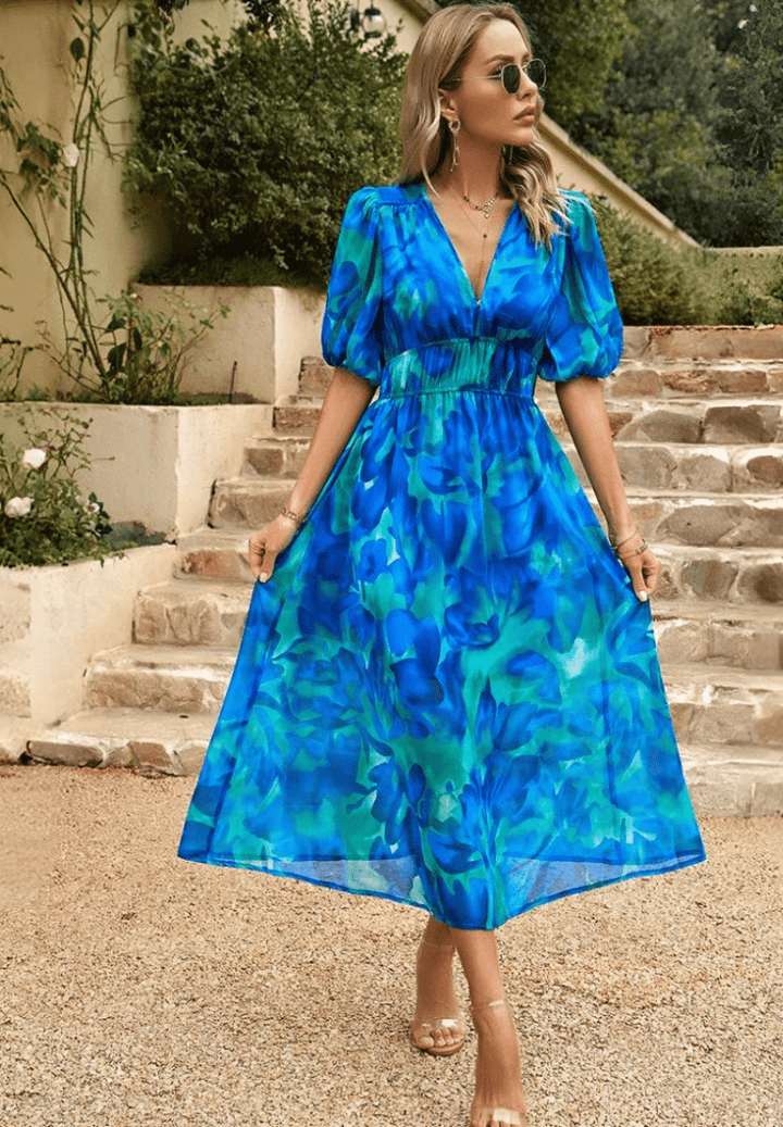 Blue abstract midi dress with V-neck, puff sleeves, and gathered waist, tiered skirt