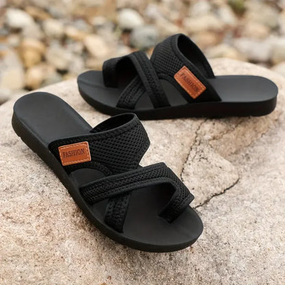 Black bunion corrector slide sandals with two cross straps and open toe