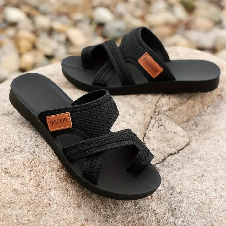 Black bunion corrector slide sandals with two cross straps and open toe