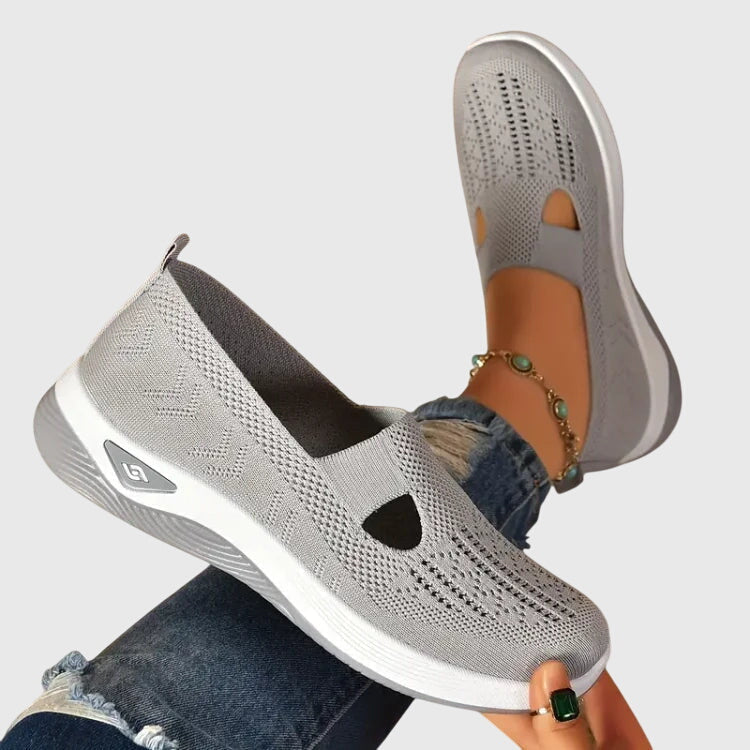 Light gray slip-on orthopedic walking shoe, knit upper with open toe cutouts, white sole.
