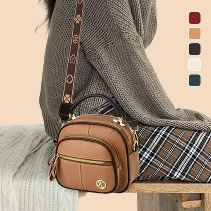 Tan mini crossbody shoulder bag with gold-tone hardware and adjustable strap