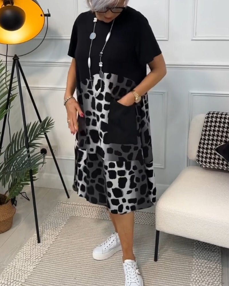 Women's black midi dress with leopard print panels, short sleeves, slightly flared hem