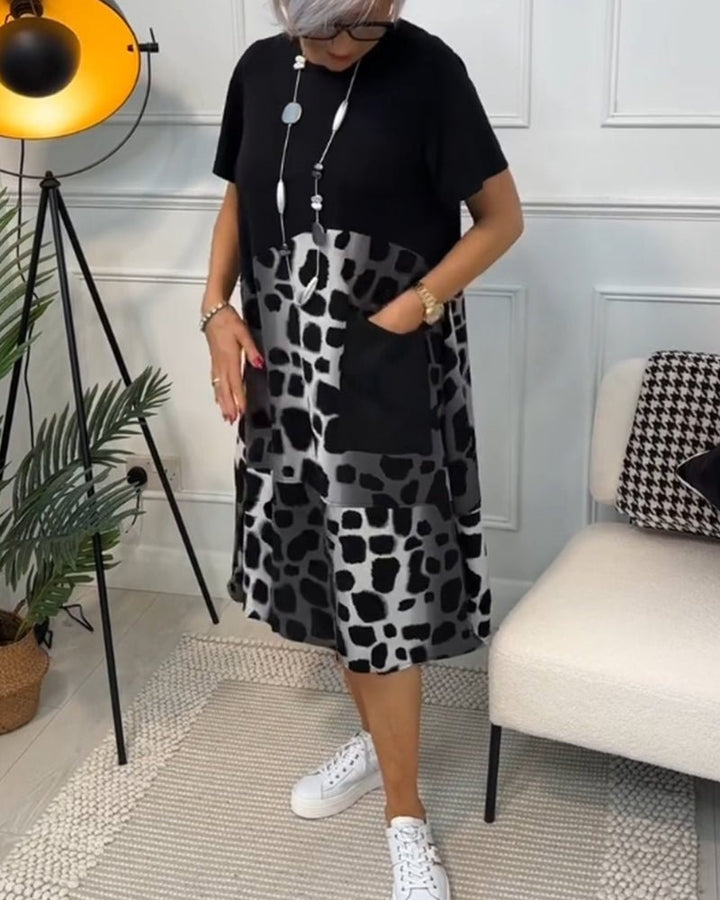 Women's black midi dress with leopard print panels, short sleeves, slightly flared hem