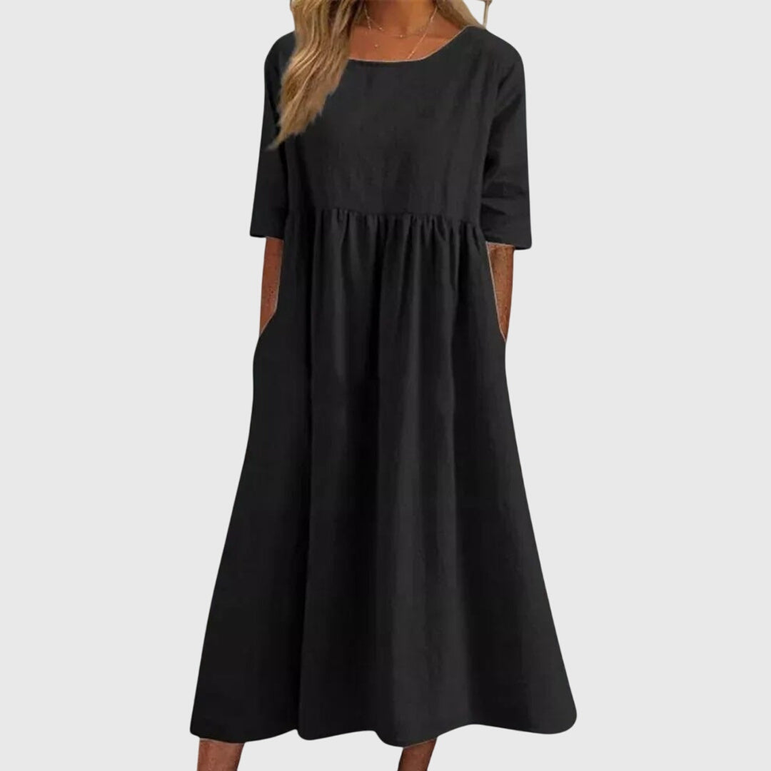 Black short-sleeve dress with round neck, gathered waist, and full midi skirt