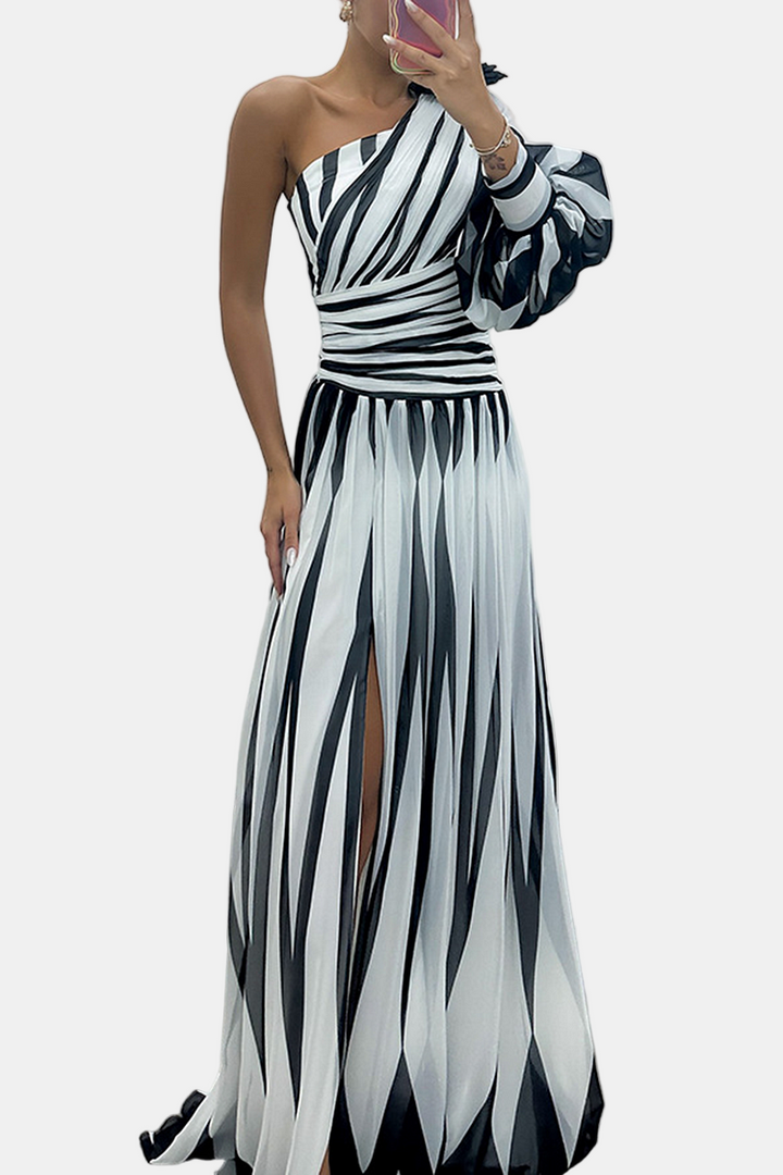 One-shoulder maxi dress in white with black striped pleats and side slit