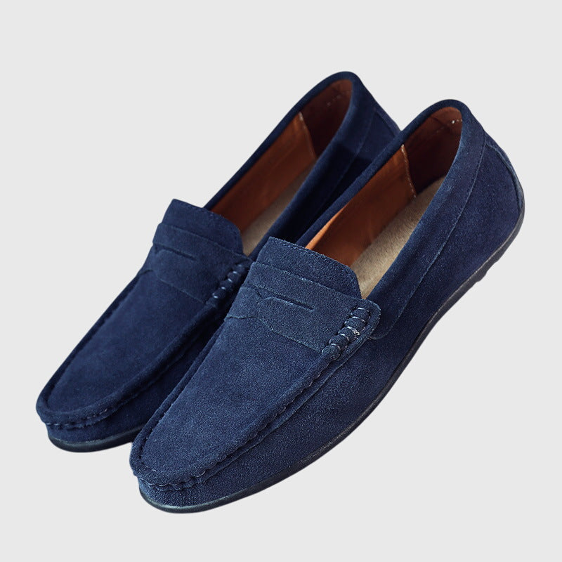 Navy suede orthopaedic loafers, angled view with penny strap and treaded sole
