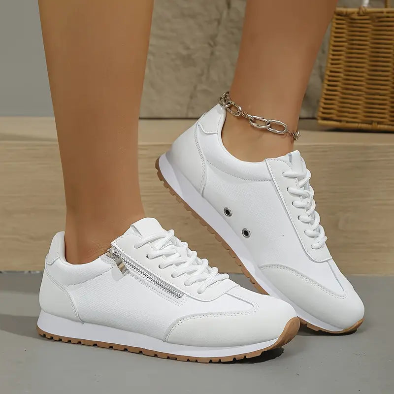 All-white casual sneakers, lace-up with side zipper and ankle chain, gum sole.