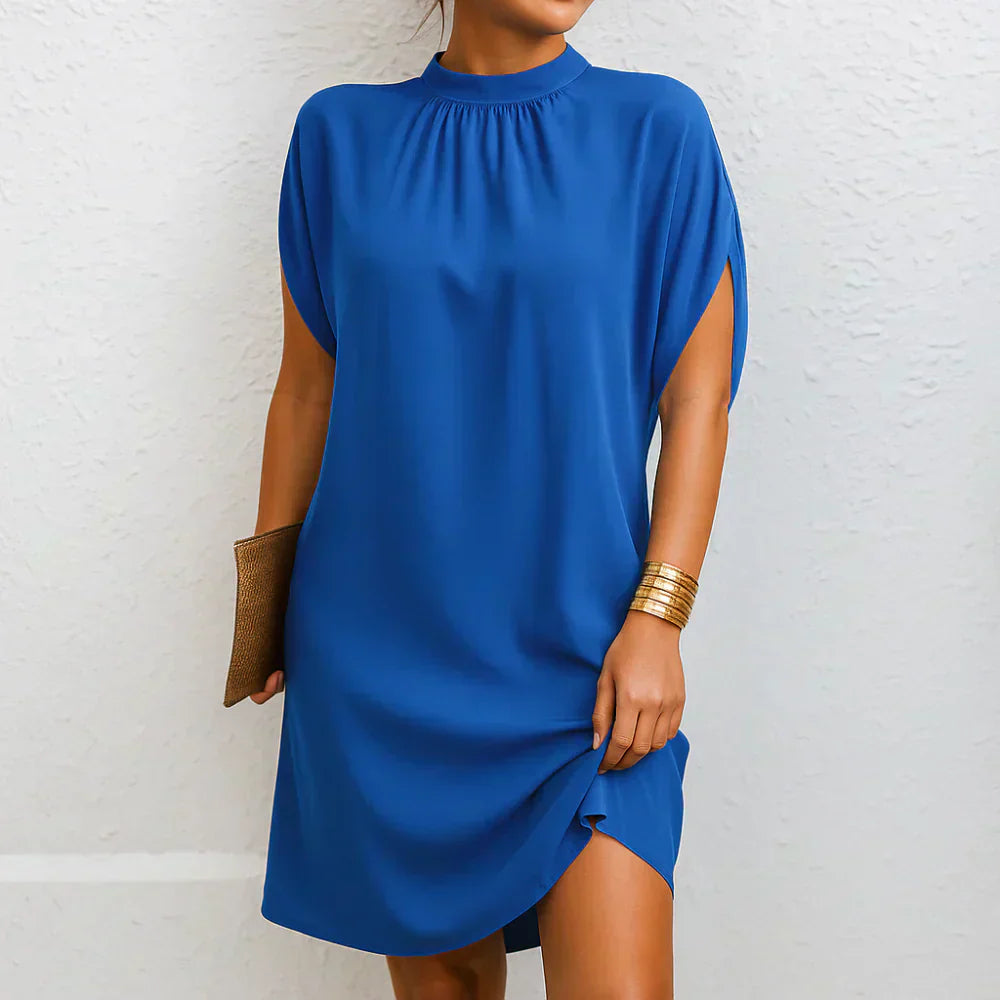 Blue mini dress with high neck, gathered yoke, cape sleeves, and side slit