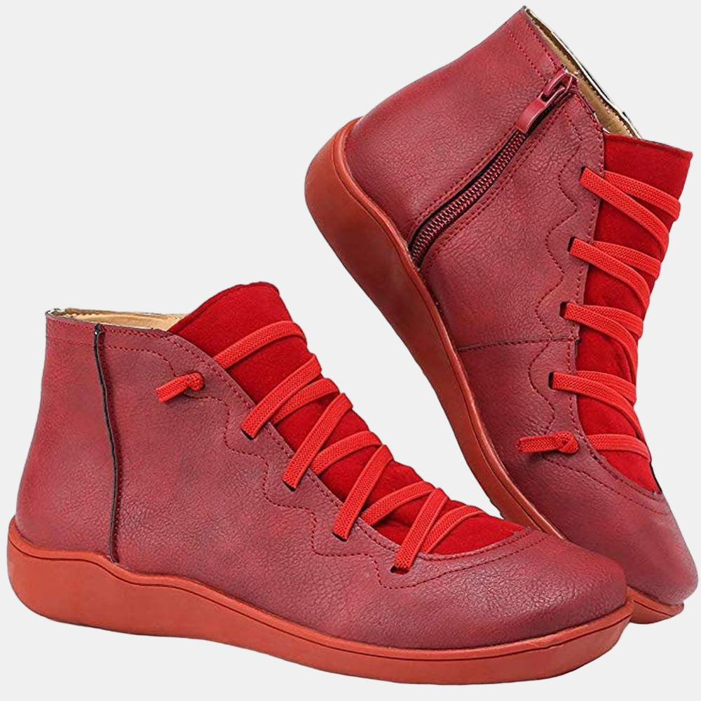 Red lace-up ankle boots with side zipper, red laces, and flat rubber sole