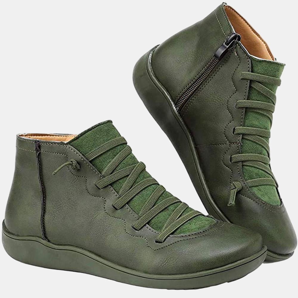 Green lace-up ankle boots with side zipper, green laces, and flat rubber sole