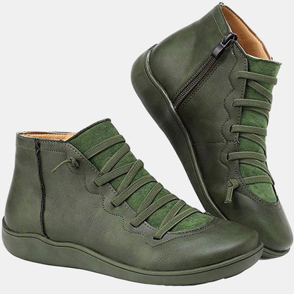 Green lace-up ankle boots with side zipper, green laces, and flat rubber sole