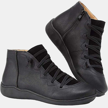 Black lace-up ankle boots with side zipper, dark laces, and flat rubber sole